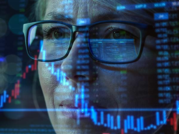woman with computer screen reflected in glasses