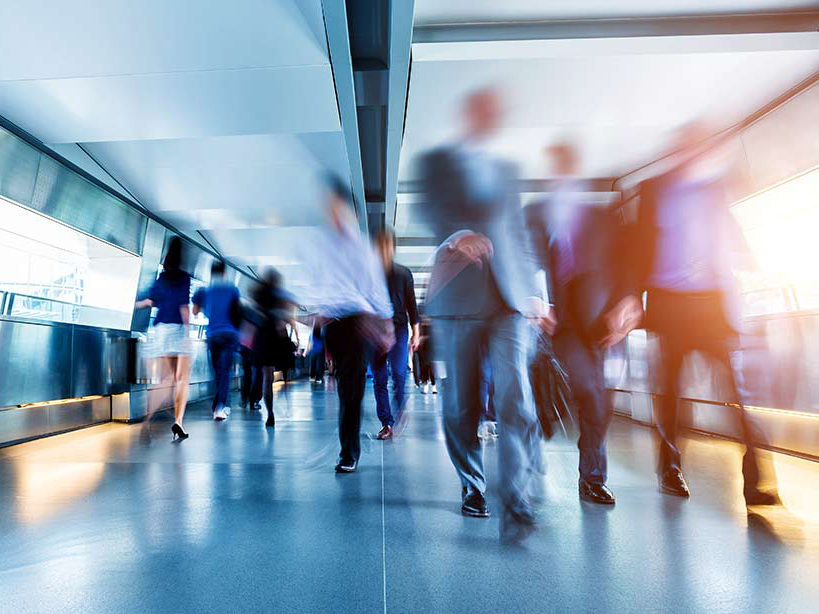 blurry people moving at speed in corridor