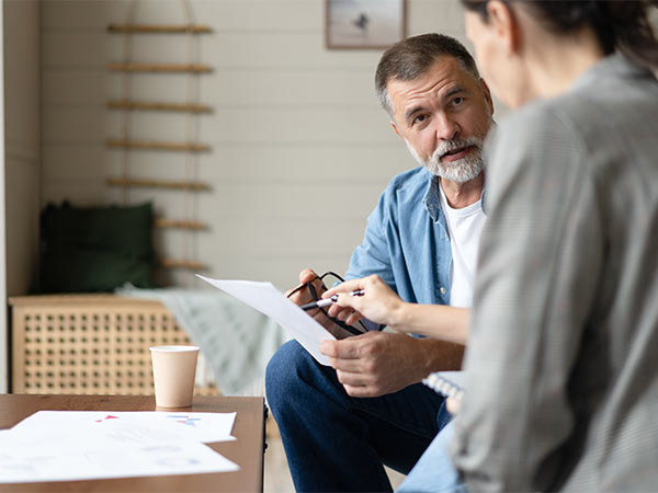 man in discussion with colleague