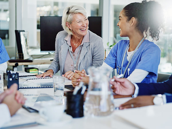 healthcare professionals laughing in meeting