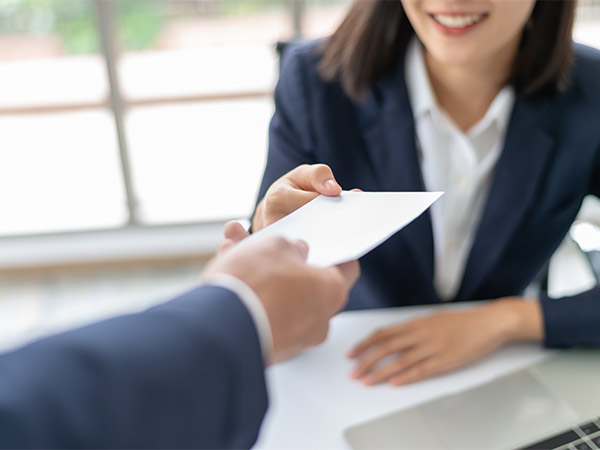 woman handing document to man