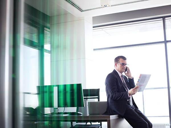 man in office looking at document